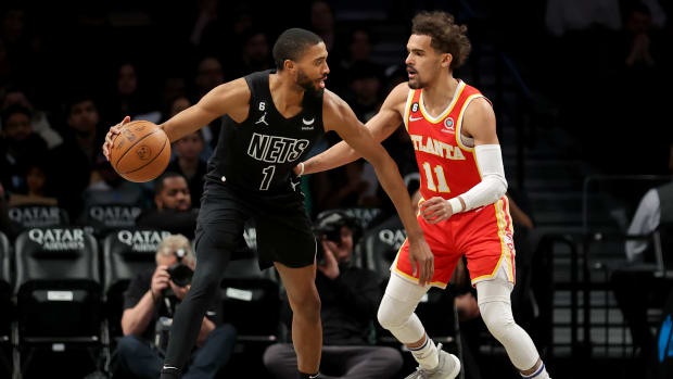 Atlanta Hawks guard Trae Young defends Brooklyn Nets forward Mikal Bridge.